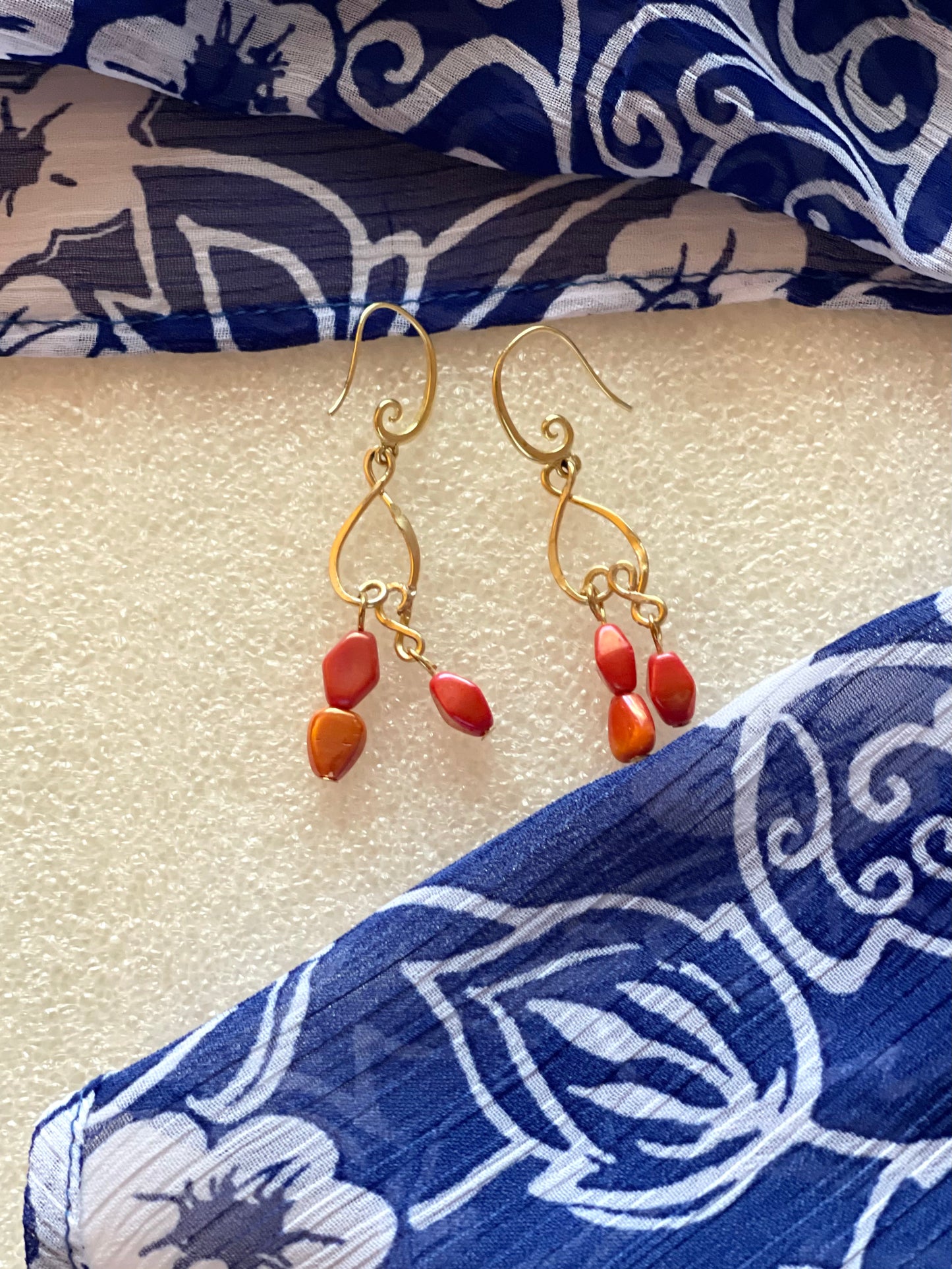 25 E19 Elegant gold dangles with red-orange accents