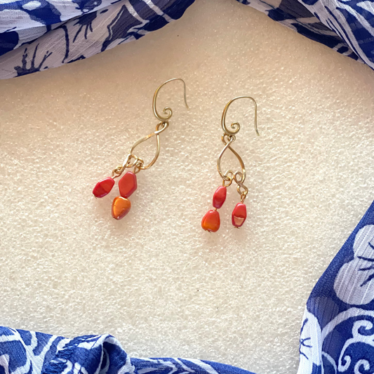 25 E19 Elegant gold dangles with red-orange accents